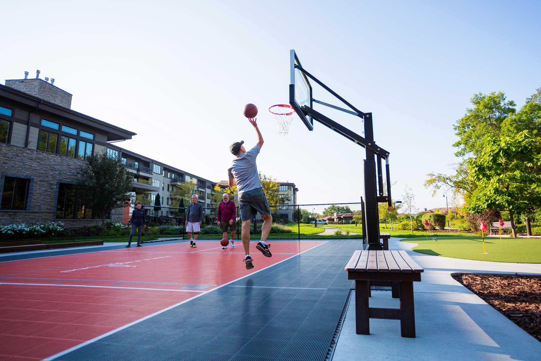 seniors playing a game of basketball outside